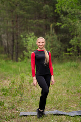 Sportive girl posing in forest