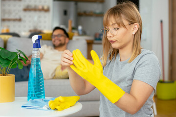 Young tired woman cleaning home. Young beautiful woman at home.	