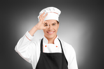 Transgender chef showing OK  on dark background