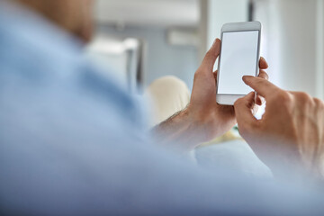 Close-up of man using mobile phone.