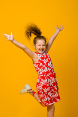 Happy carefree child emotions. Energetic joyful adorable little girl laughing at joke on yellow background.