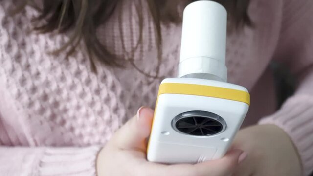 A modern USB PC-based spirometer. Close-up of a modern spirometer in the hands of a patient. Measures lung function - the amount and speed of air that can be inhaled and exhale. Spirometry