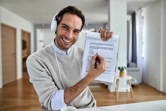 Happy Entrepreneur Filling Insurance Policy At Home And Looking At Camera.