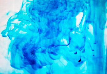 Forms of spilled blue ink in water. Art in the fluid
