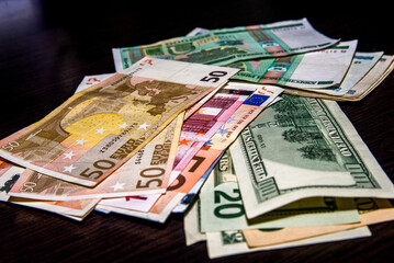 Obraz na płótnie Canvas Euro and dollars on a black background