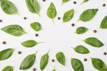 Top above overhead view photo of basil leaves and peppercorns isolated on white background