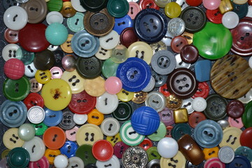 Close up of a panel of multicolored buttons sewn on the fabric