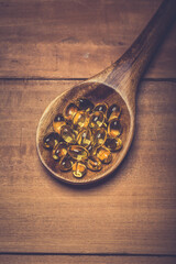 Cod liver oil capsules in a fish shape with copy space. Healthcare concept