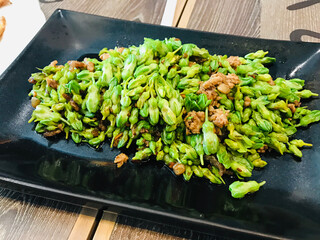 Telosma cordata or Cowslip creeper flower stir fried with minced pork.