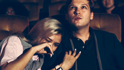 People audience watching movie in the movie theater cinema. Group recreation activity and...