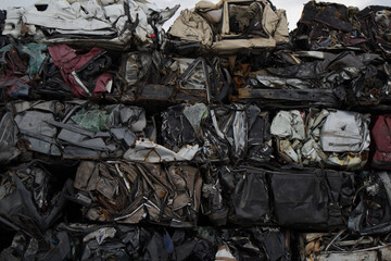 A car graveyard, with a huge amorphous mass of iron of damaged vehicles, one on top of each other, which awaiting to be recycled, Kozani, Greece.