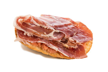 Mollete with jamón ibérico and tomato, typical spanish food, isolated on white background.