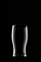 Empty glass on black background, copy space