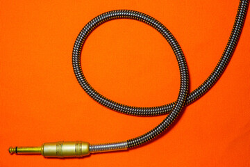 guitar cable audio  on orange background music concept
