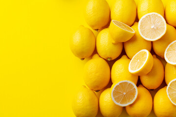 Fresh lemons on yellow background. Copy space. Top view.