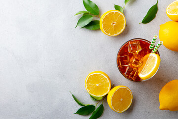 Ice tea with fresh lemons. Grey background. Copy space. Top view.