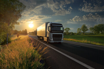 Fototapeta na wymiar White truck transport on the road at sunset and cargo
