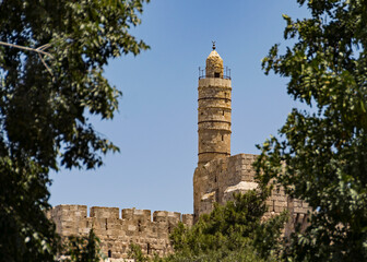 Fototapeta na wymiar tower of david migdal david citadel mosque and museum in the old city of jerusalem israel framed by blurred foreground foliage