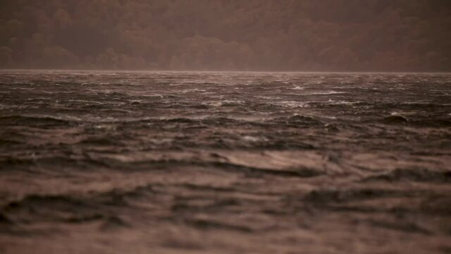 Extreme gale force winds blowing across a loch in Scotland