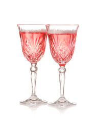 Glasses of tasty champagne on white background