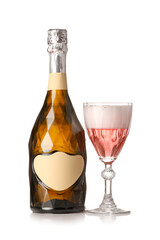 Bottle and glass of tasty champagne on white background