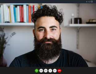 Friendly millennial hipster video call in lockdown from Coronavirus, Covid-19 - Young man in...