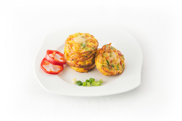 Fresh egg omelet muffins on the white dish. Ideas for healthy breakfast. isolated on white.