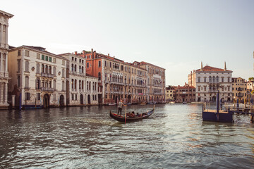 A gondolier rowing his Gondola on the famous Grand Canal, Venice, Italy