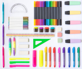 School and office supplies of various colors: rulers, erasers, markers, pens, pencil sharpeners on...