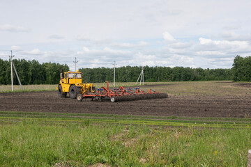 Fototapeta na wymiar Combine harvester working on field. Field cultivation agricultural sector work