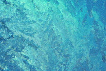 Abstract spotted turquoise, aquamarine and blue background. Chaotic spots and stains, similar to seething sea waves. Bright color background or wallpaper