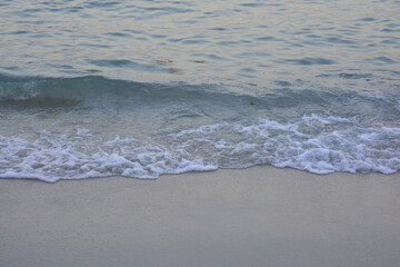 Wave of sea water and sand in evening