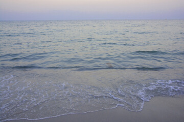 Wave of sea water and sand in evening