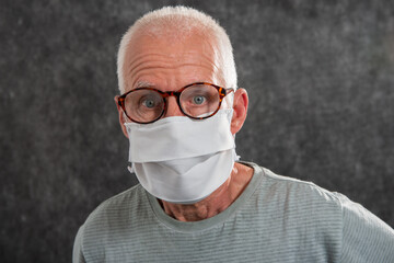 Portrait of an senior man in a medical mask. Concept of the danger of coronavirus