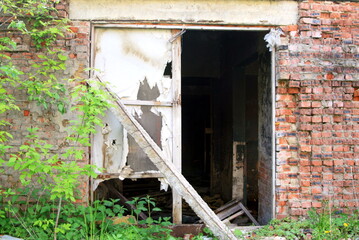 entrance to an old abandoned brick house