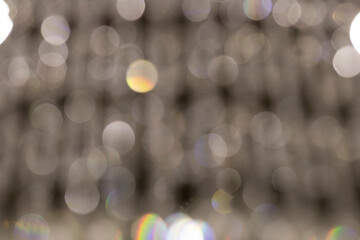 Different size colored bokeh on a white background.