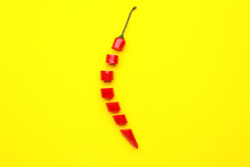 Cut chili pepper on color background