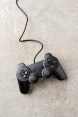 Overhead shot of video game controller on stone background. Close up