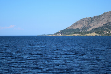 Fototapeta na wymiar Seascape with Saos mountain and coastline Katsampas area - Samothraki island view from ferry - Greece, Aegean sea