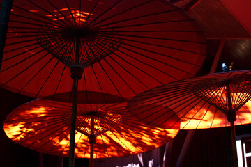 Red umbrellas in thai traditional garden