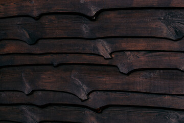 A fragment of a strong wooden fence. Horizontal boards are tightly nailed to each other and provide...