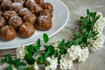 a lot of delicious truffles from dried fruits, sprinkled with powdered sugar, tasty, healthy and beautiful dessert