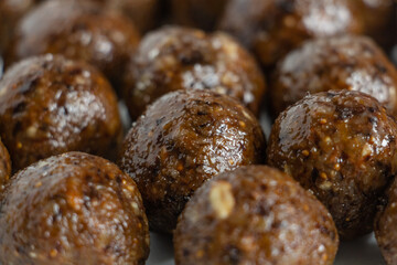 a lot of delicious truffles from dried fruits, sprinkled with powdered sugar, tasty, healthy and beautiful dessert
