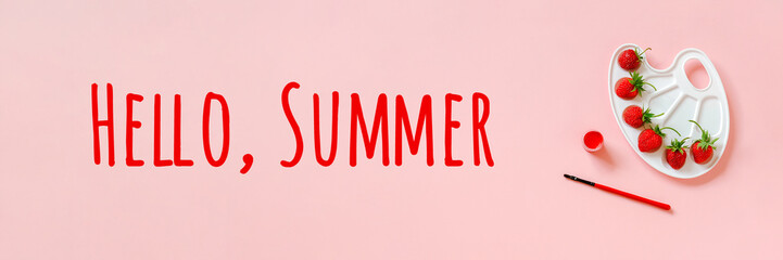 Hello summer texn Red ripe strawberries on artistic palette, brush and gouache on pink background Creative concept summer colors paint