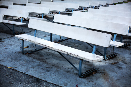 rowa of empty benches at an outdoor theater