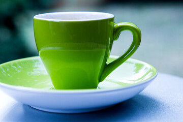 close-up of a green cup outdoors on table