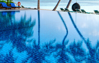 Private oceanfront pool with submerged loungers in a luxury resort in Maldives, Indian Ocean