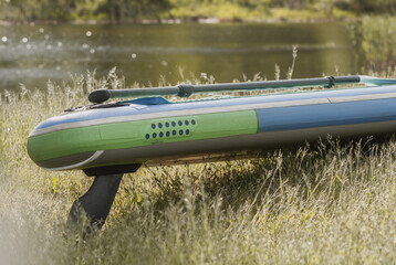 Paddle Board close-up outdoors, paddleboard in the grass,