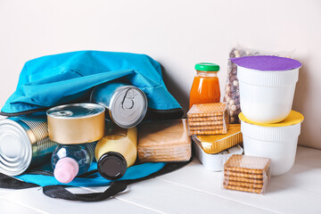 Schoolbag with different products on table. Concept of Backpack Food Program
