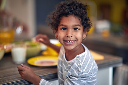 Afro American  girl having breakfast at morning.